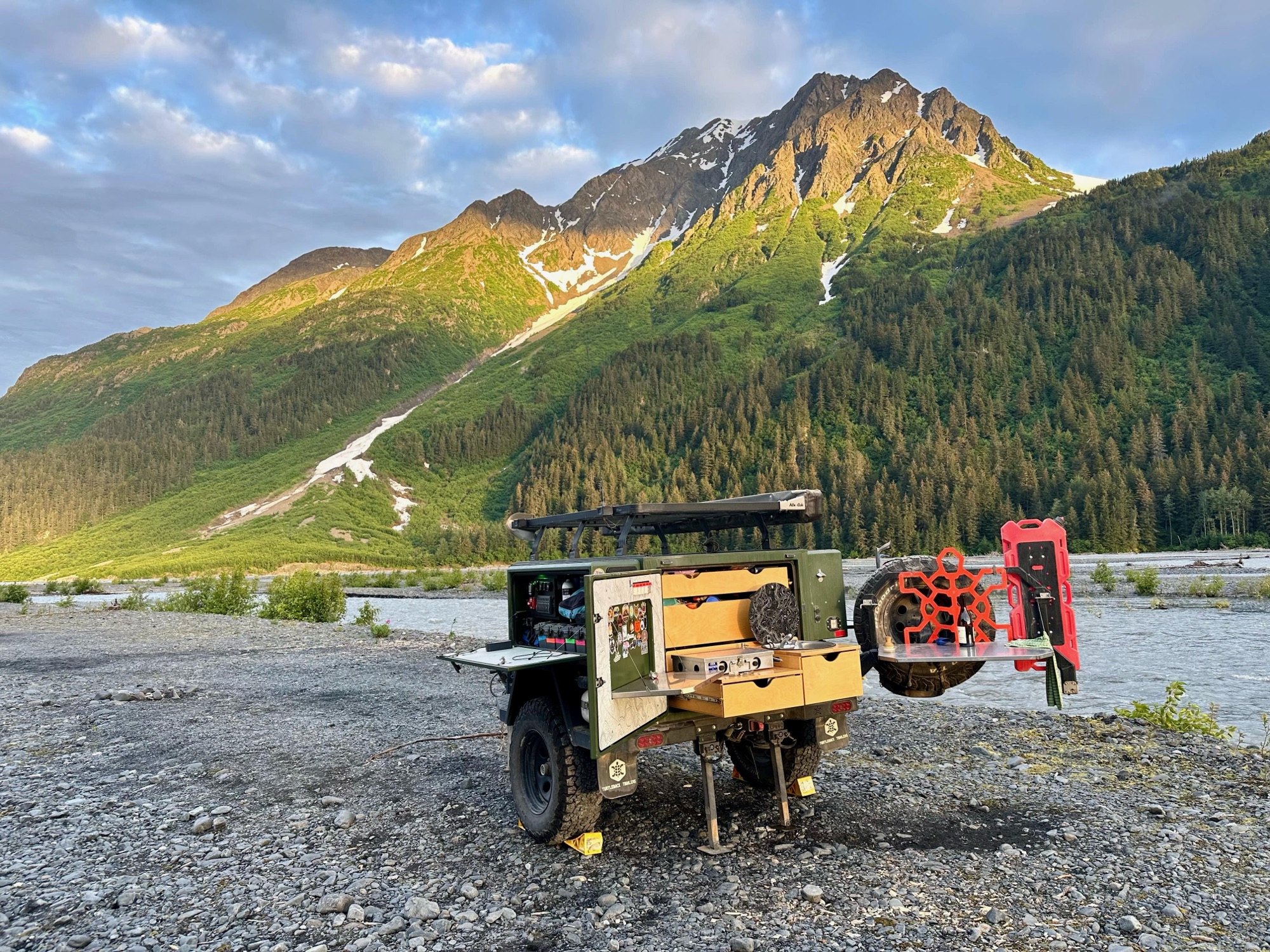 2021 Turtleback Expedition at a backcountry camp beneath snow-streaked mountains