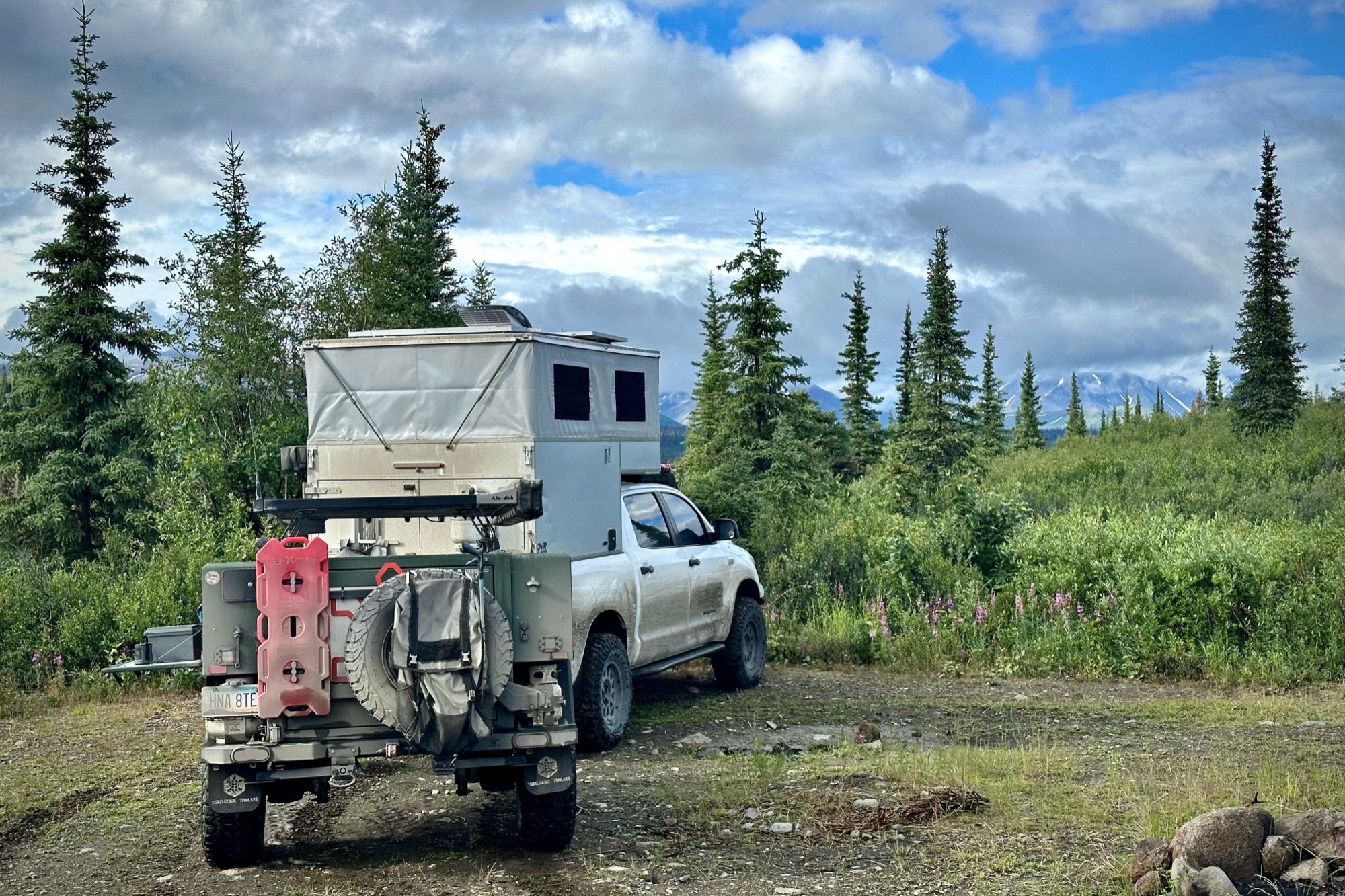 Alaska backcountry camp with a rainbow overhead
