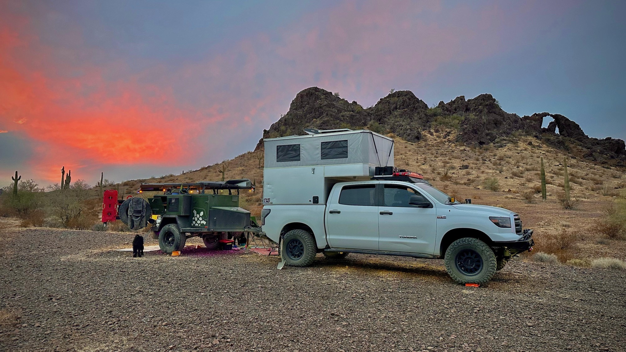 Desert sunset camp beneath crimson Arizona skies