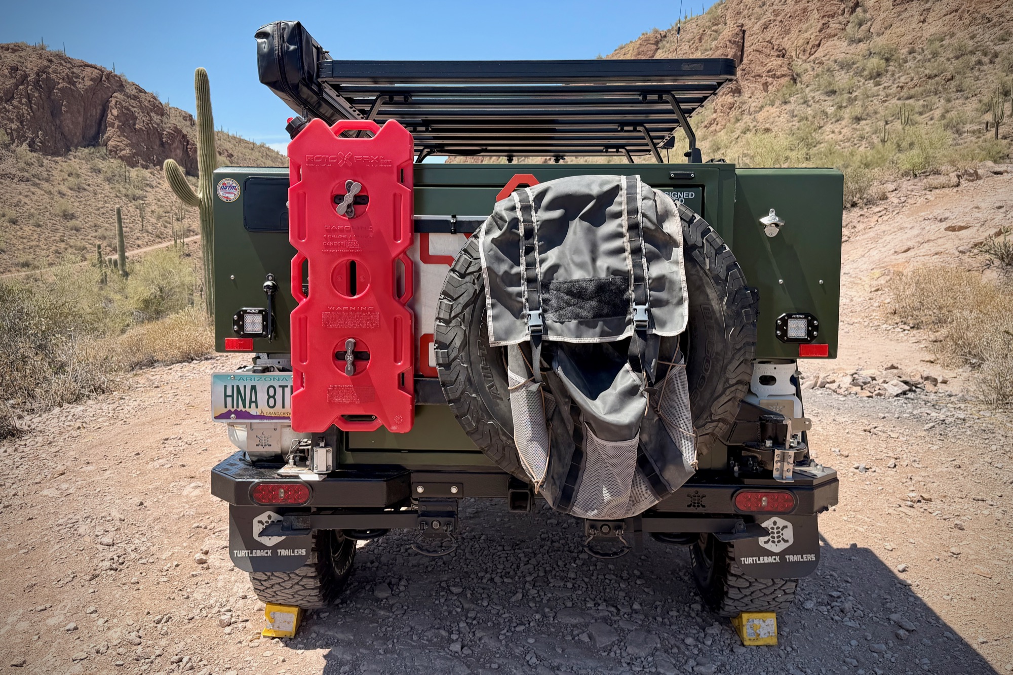 Straight-on rear — spare, jerry cans, lighting
